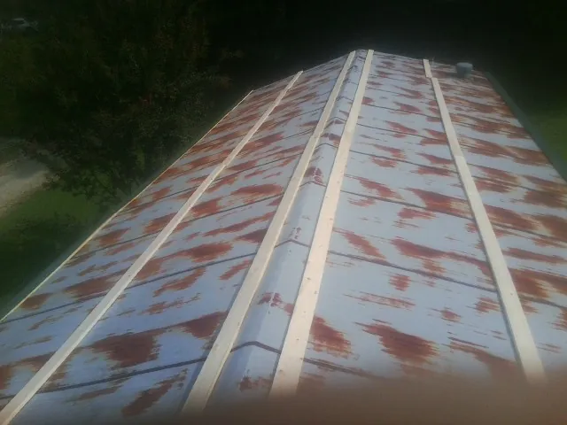 Rusted metal roof panels with new wood purlins before replacement — Storm Damage Roof Repair in Berrien Springs by Roofing Brothers